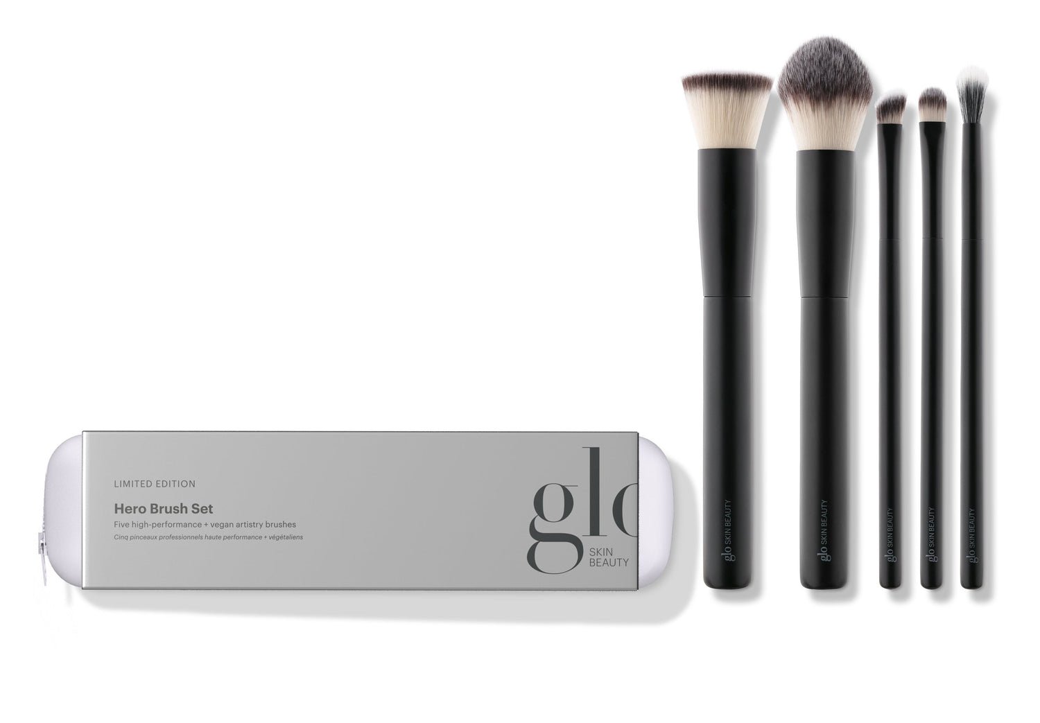 A collection of five high-performance, vegan makeup brushes displayed alongside their packaging which reads 'hero brush set'. The brushes are designed for various makeup applications including powder, concealer, foundation, eyeshadow, and eyeliner.
